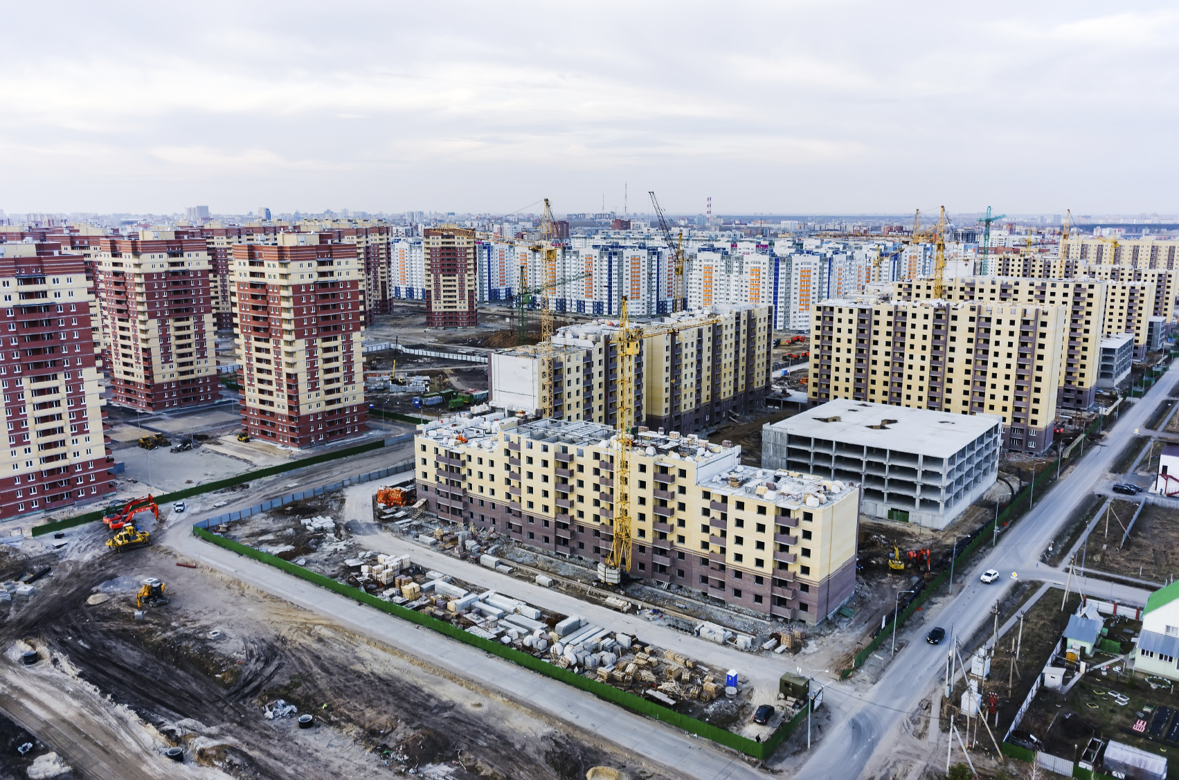 Aerial view on lifting cranes on construction site of residential house in Tyumen, Russia