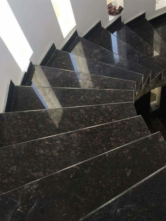 Sleek black granite staircase design