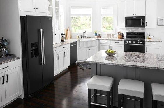 White kitchen with black appliances