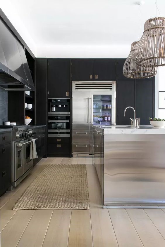 Black and white modular kitchen with use of stainless steel