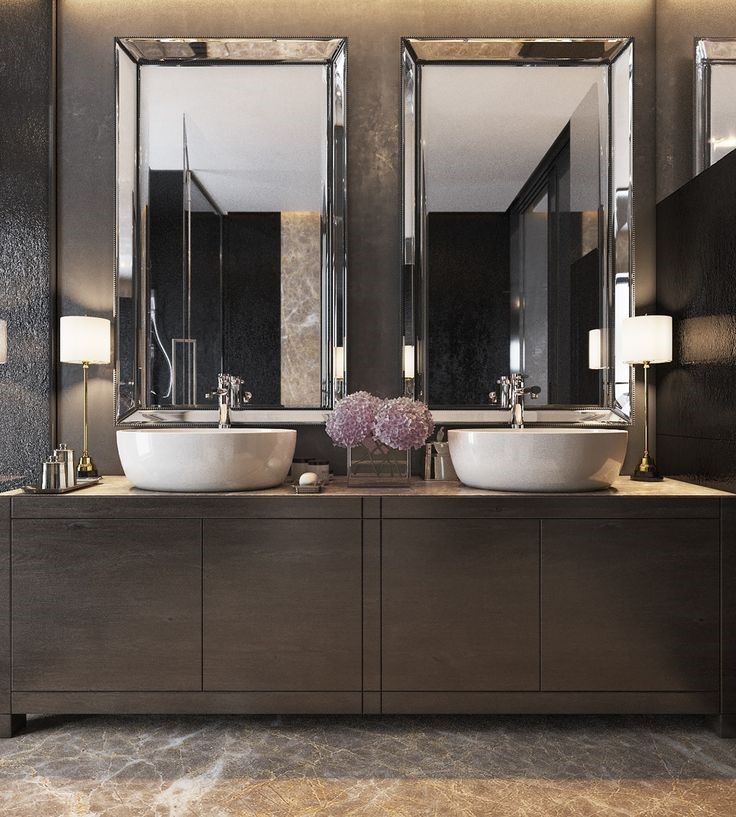 Mirrors framed by reflections in a classic office washroom